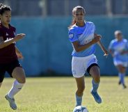 Transgender footballer Mara Gomez of Villa San Carlos vies for the ball with Luciana Nievas of Lanus