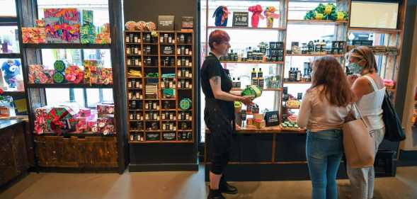 People wearing protective face masks shop in Lush in Bournemouth in June2020