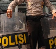 A police officer stands guard at the front of the Marriott hotel in Jakarta, Indonesia