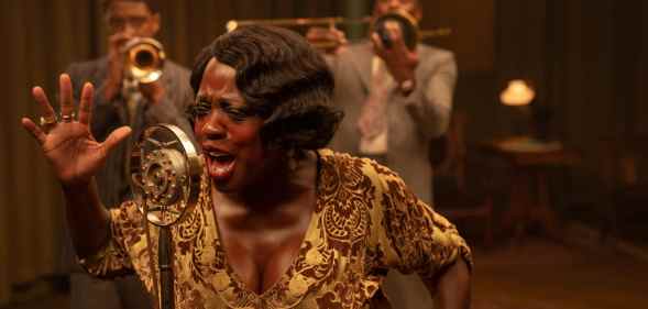 Chadwick Boseman as Levee, Viola Davis as Ma Rainey and Colman Domingo as Cutler in a recording studio