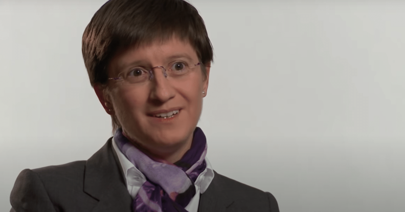 Julia Hoggett wearing a suit against a white backdrop