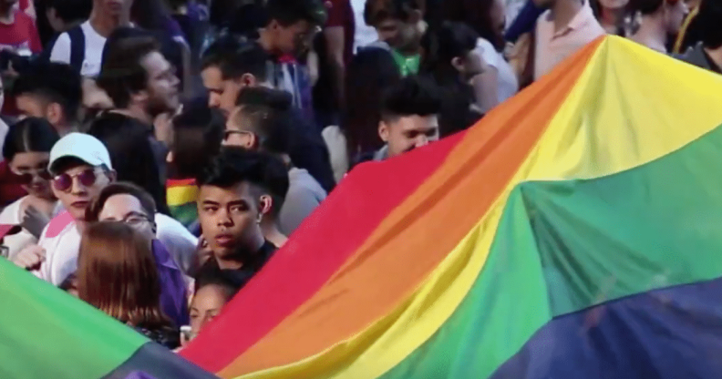 Protesters holding a giant Pride banner