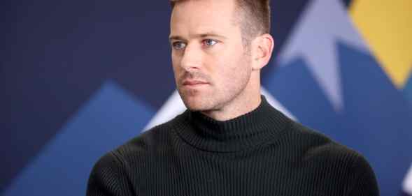 Armie Hammer in a black turtleneck looking to the right