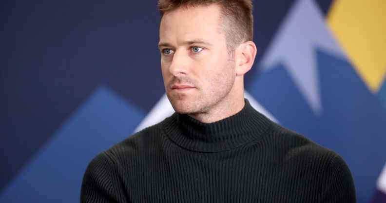 Armie Hammer in a black turtleneck looking to the right