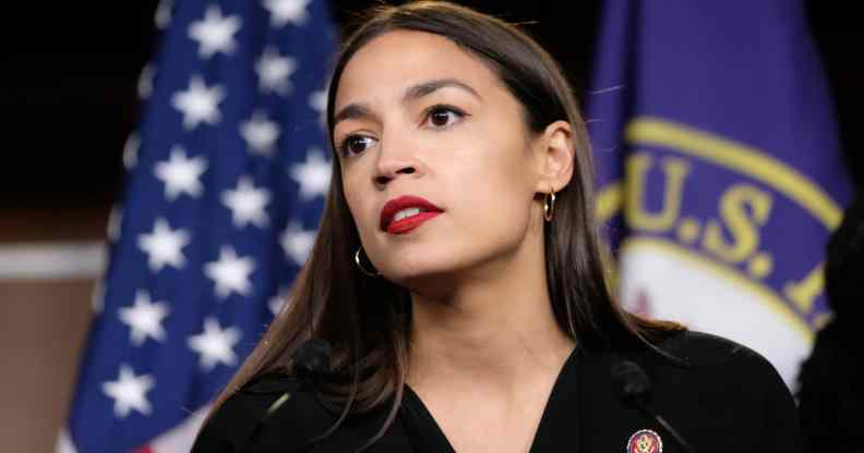 Alexandria Ocasio-Cortez in front of a US flag