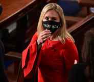 Marjorie Taylor Greene in a red top and 'Trump Won' face mask