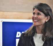 Nikki Haley smiles in a white ribbed top and black jacket