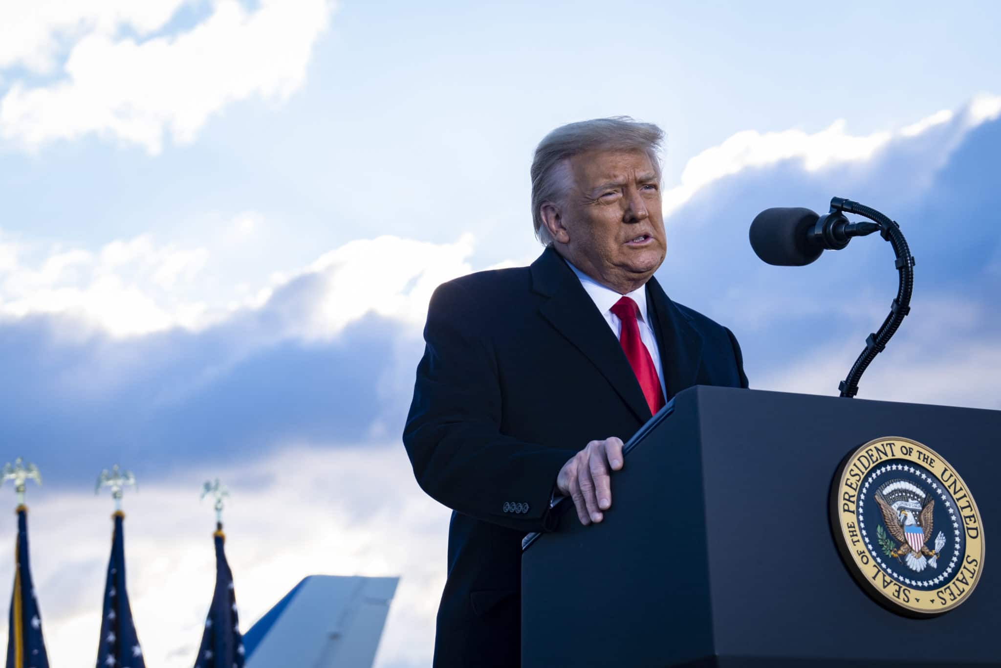 President Donald Trump speaks to supporters at Joint Base Andrews before boarding Air Force One for his last time as President. 