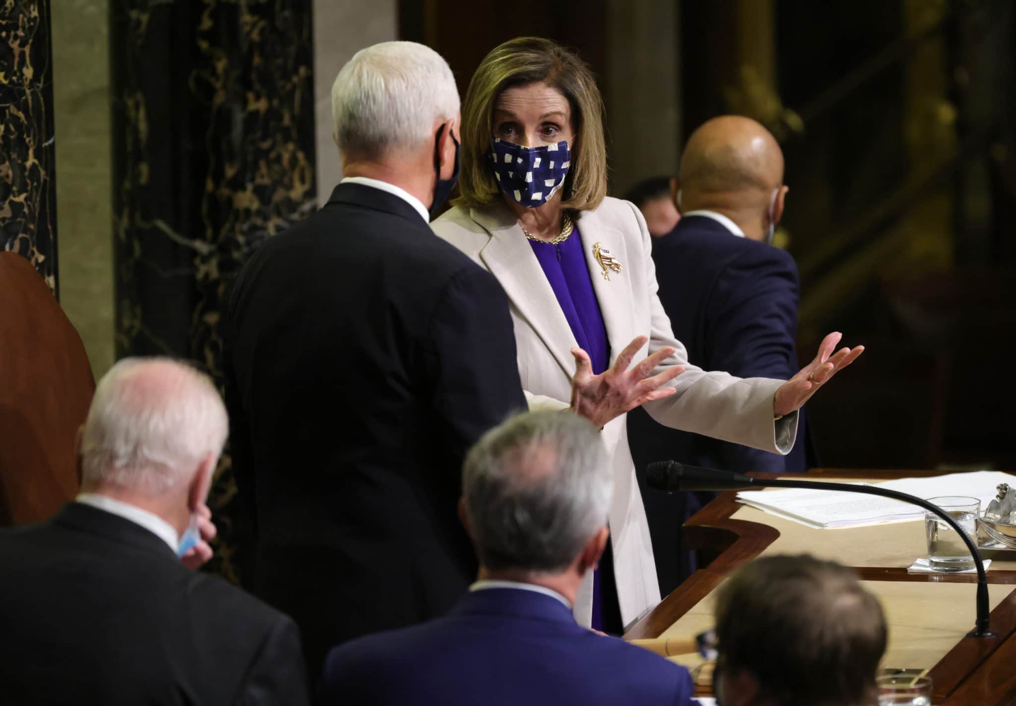 Speaker of the House Nancy Pelosi talks with vice president Mike Pence after the conclusion of the count of electoral votes in the House chamber