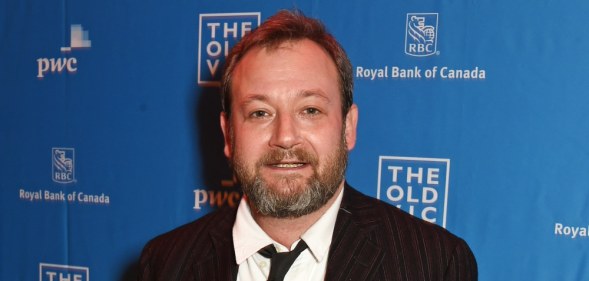 James Dreyfus in a white shirt, black tie and blazer