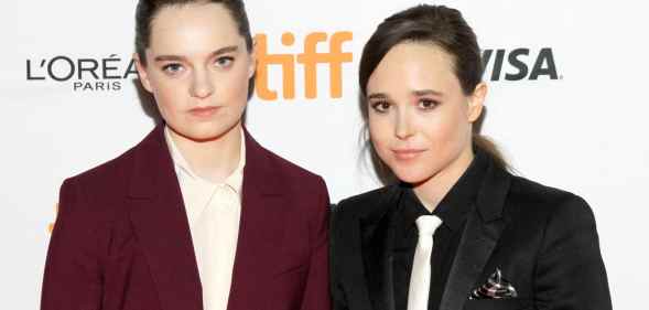 Emma Portner in a burgundy suit and Elliot Page in a black suit and white tie