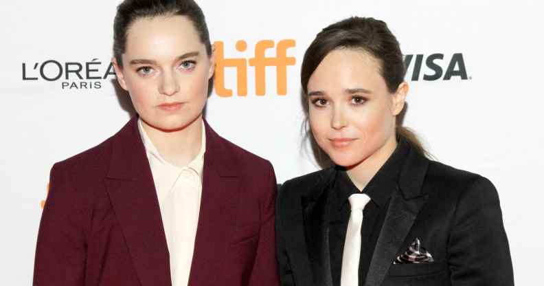 Emma Portner in a burgundy suit and Elliot Page in a black suit and white tie