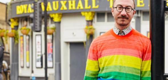 Philip Normal wearing a rainbow jumper standing outside the Royal Vauxhall Tavern