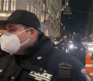 NYPD officers outside Trump Tower. One is close to the camera wearing a face mask