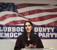 Addison Perry-Franks speaks behind an American flag