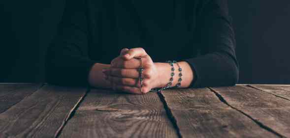 Nun praying with rosary