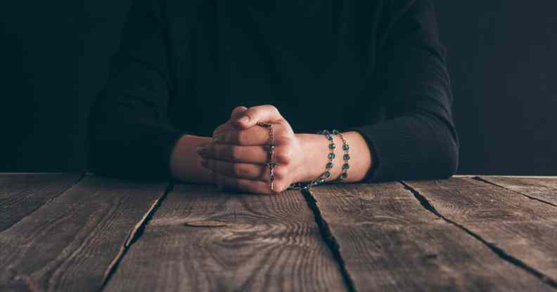 Nun praying with rosary