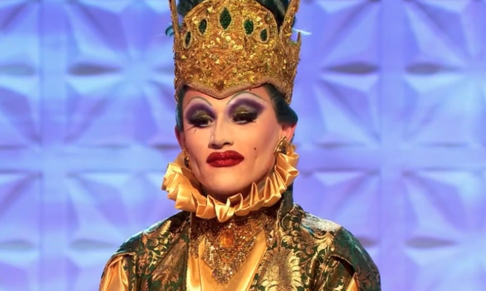 Joe Black in a gold ruffed dress and Brighton Pavillion-inspired ornate gold headpiece