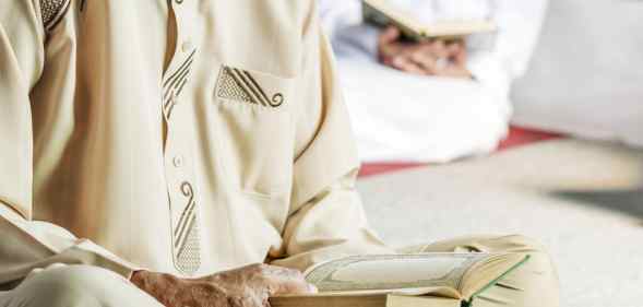 A muslim man reading from the quran