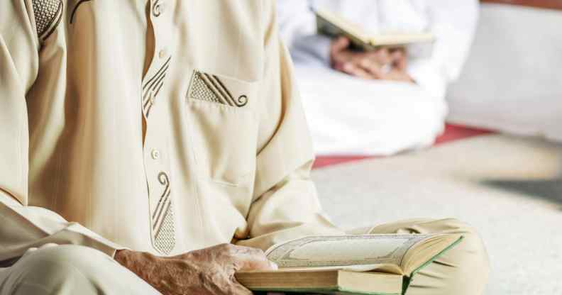 A muslim man reading from the quran