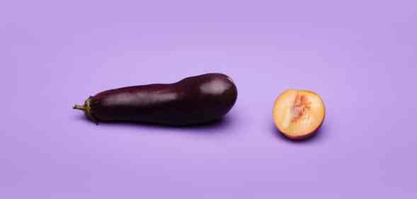 An aubergine and a peach, cut in half, against a purple background