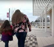 woman and her daughter walking together back portrait