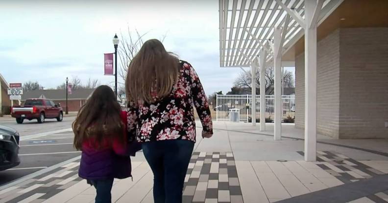 woman and her daughter walking together back portrait