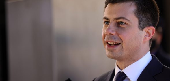 Secretary of transportation Pete Buttigieg speaks in front of a podium