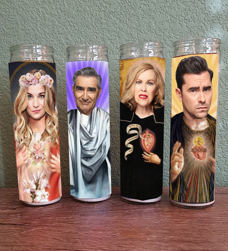 The Saint themed candles. (InkAndBeats/Etsy)