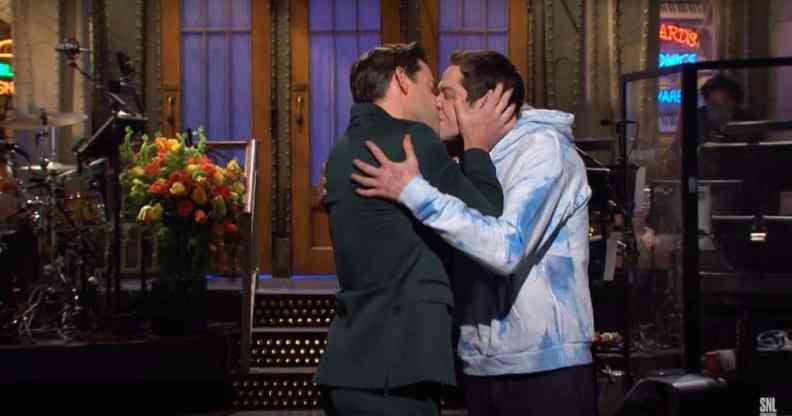 John Krasinski and Pete Davidson share a kiss on the set of Saturday Night Live