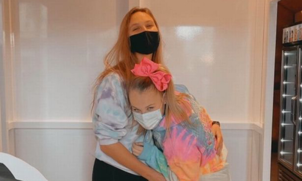 JoJo Siwa hugs her girlfriend