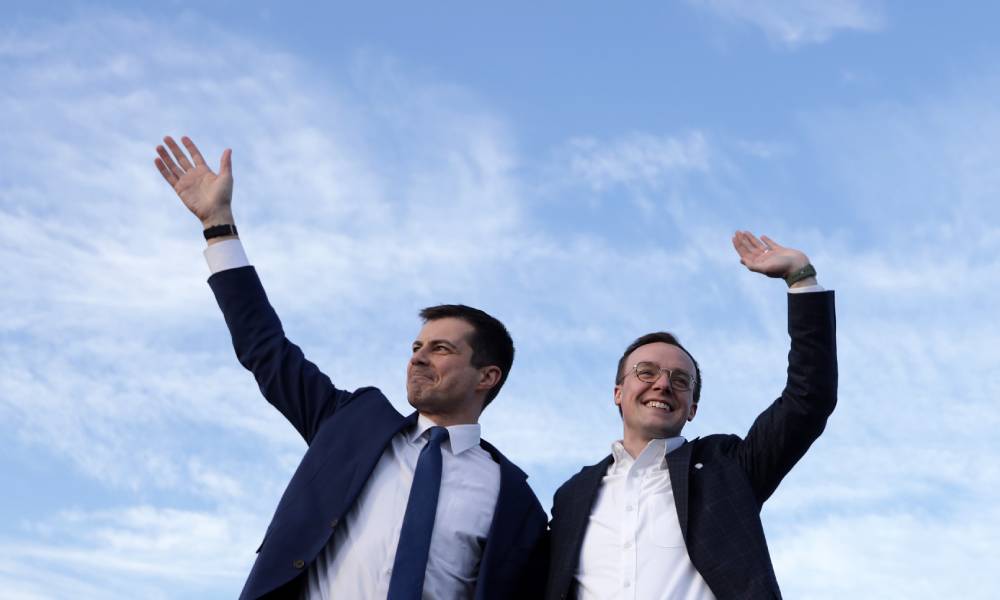 Pete and Chasten Buttigieg waving