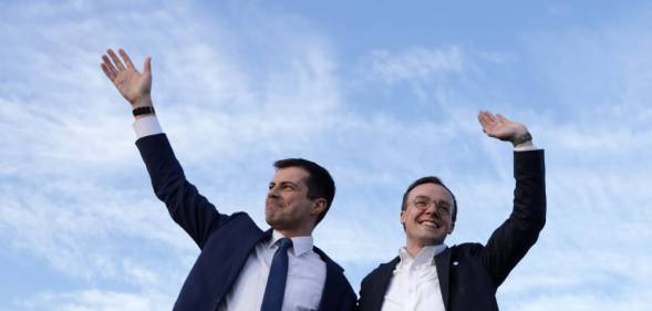 Pete and Chasten Buttigieg waving