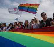 Members of the Alliance of Heterosexuals and LGBT for Equality, their flag on the left, at the St Petersburg LGBT+ Pride