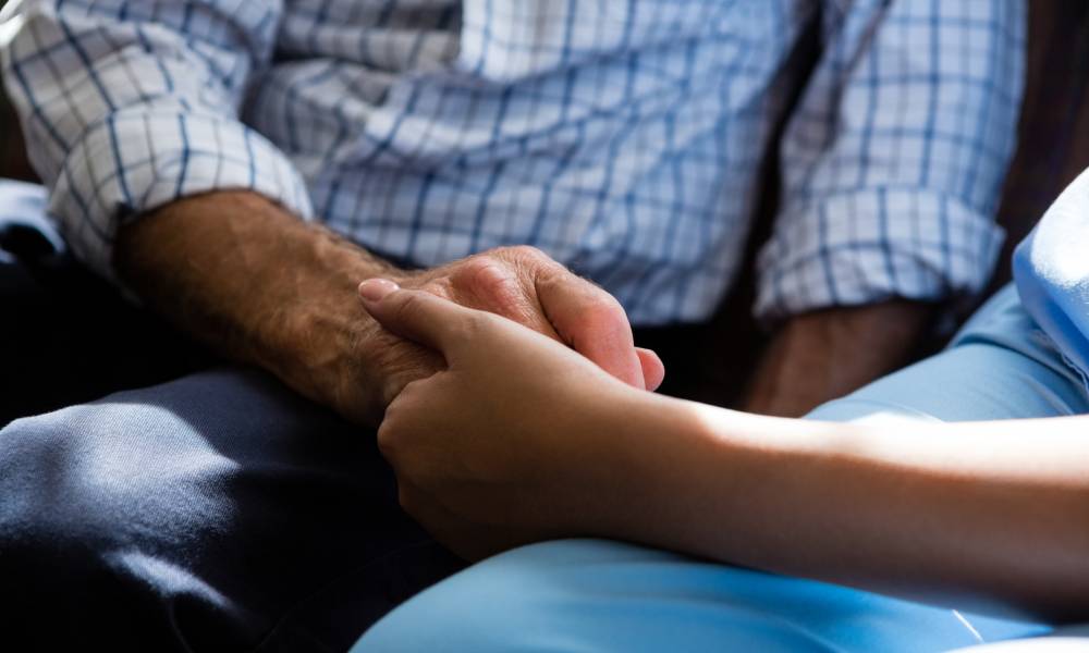 doctor holding hand of older person