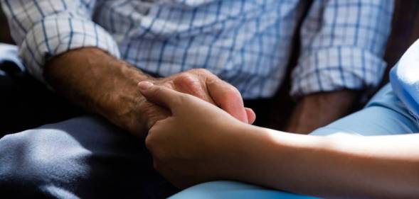 doctor holding hand of older person