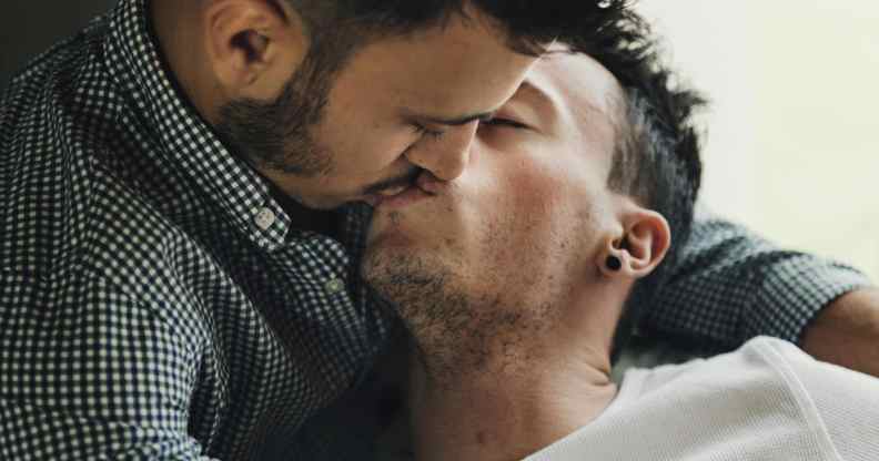 Two men kissing