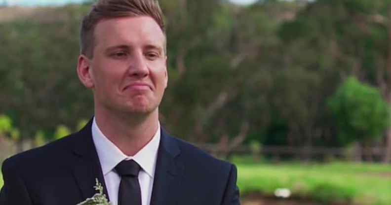 Liam Cooper smirks in a suit against a wooded backdrop