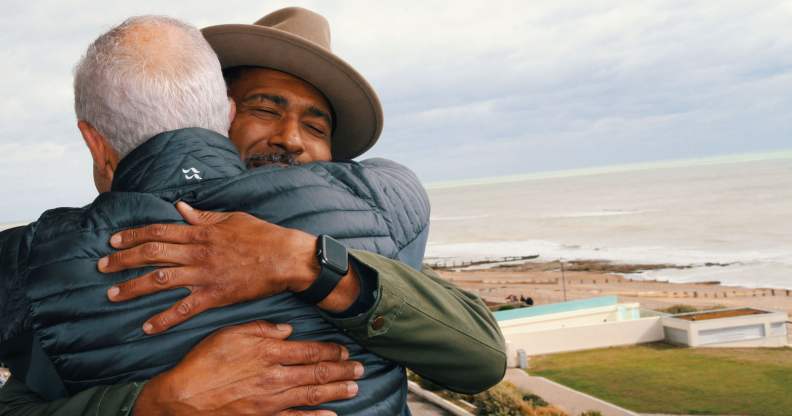 Marc and John hugging, taken over John's shoulder