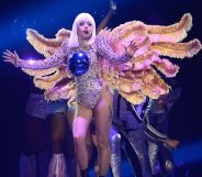 Lady Gaga, wearing a winged costume with a blue ball on her chest, performs onstage during The ARTPOP Ball tour opener