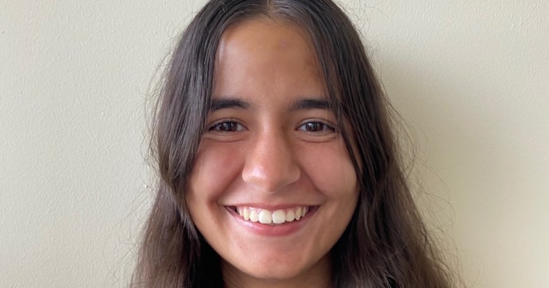 A headshot of Leonor Silva smiling against a grey background