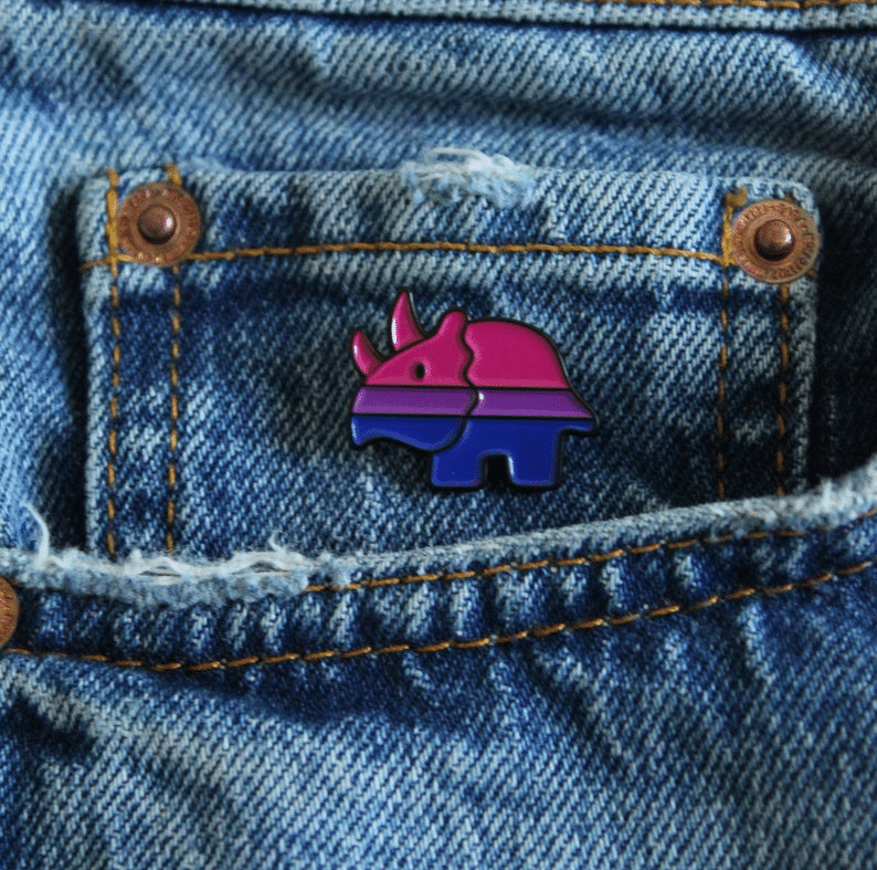 A dinosaur Pride pin. (utterlyqueer)