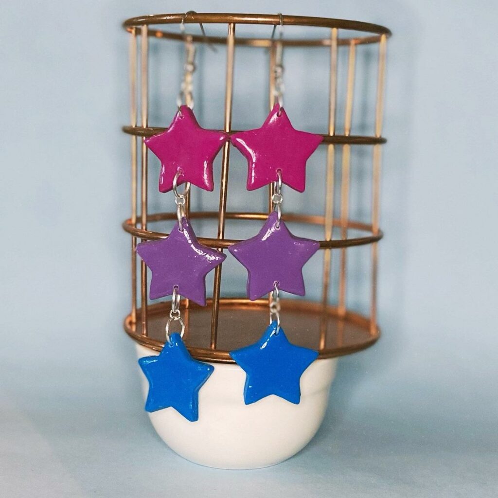 Dangly star earrings in the bi flag colours. (Etsy/librarights)