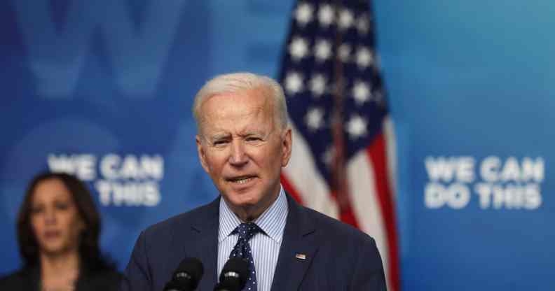 President Joe Biden (R) speaks as vice president Kamala Harris (L) listens