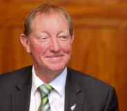 New Zealand MP Nick Smith smiles wearing a suit and tie