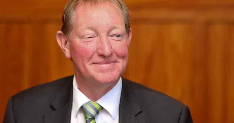 New Zealand MP Nick Smith smiles wearing a suit and tie