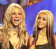 Britney Spears laughs as Christina Aguilera looks on at the MTV VMAs