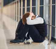 Boy in uniform sitting alone with feeling sad at school. Conception of harassment.