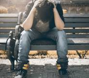 sad man by himself outside on park bench