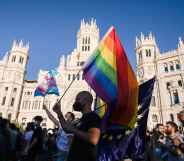 A protester waves a Pride flag in Madrid, Spain